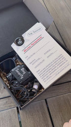 detailed video showcasing each product for the full set of ring security proposal box. open box, set 1 includes a ring security "mission assignment" card with a ring security agent id badge, sunglasses, play binoculars, agent earpiece, black whistle, "ring security" sticker, personalized black car with a name. the inside of the box is filled with Kraft colored paper filler.